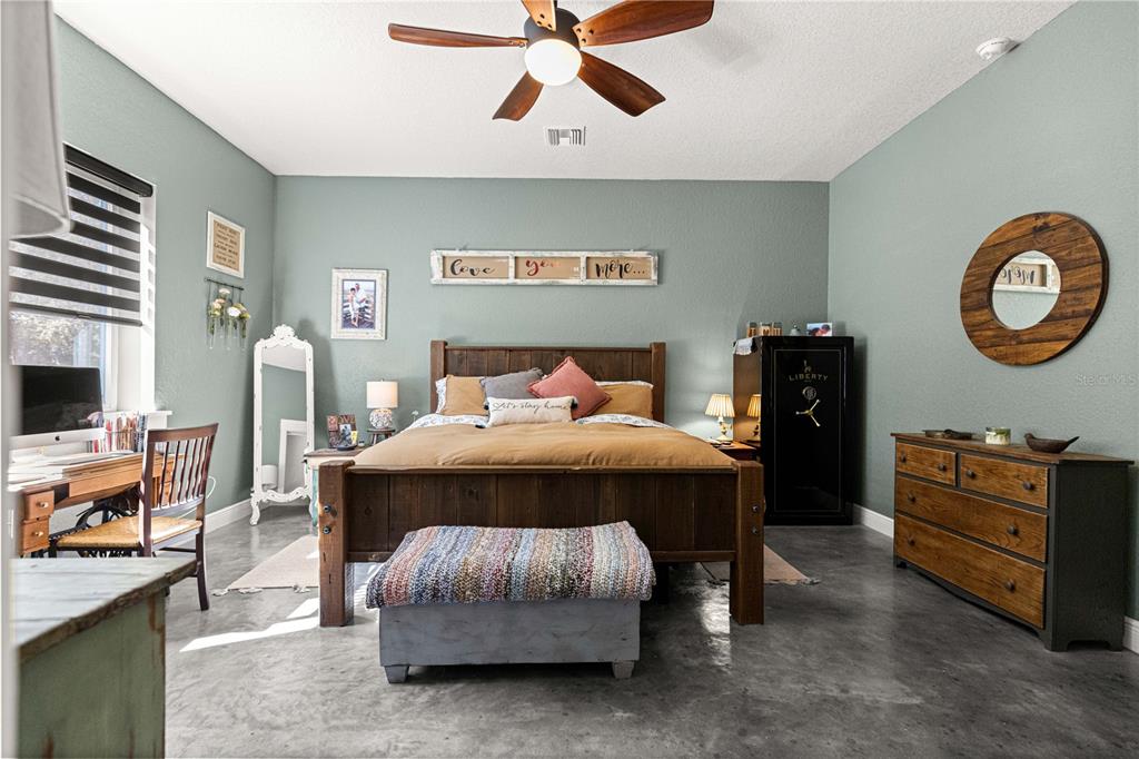 4120 Southwest 199th Court Dunnellon, FL 34431 - Photo 41 of 82 a bedroom with a bed and a chandelier