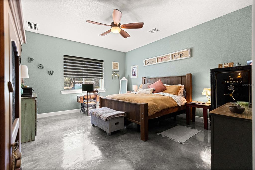 4120 Southwest 199th Court Dunnellon, FL 34431 - Photo 42 of 82 a bedroom with a bed and a chandelier