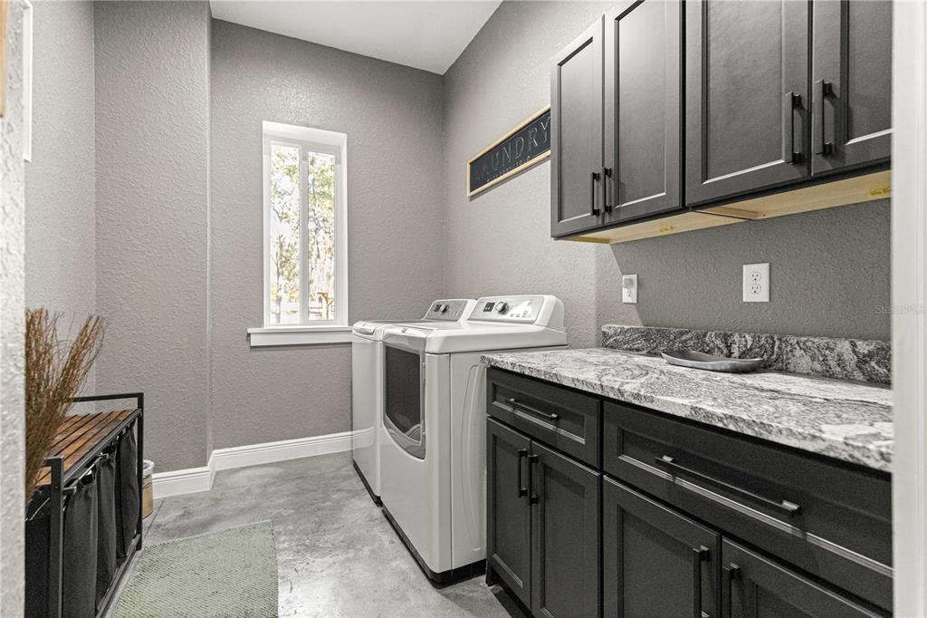 4120 Southwest 199th Court Dunnellon, FL 34431 - Photo 48 of 82 a utility room with granite countertop a sink a stove and cabinets