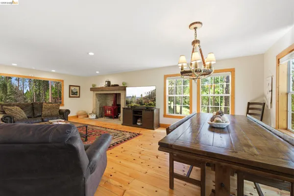 a living room with furniture a fireplace and a chandelier
