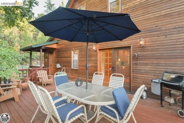 a patio with a table and chairs under an umbrella