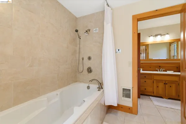 a bathroom with a tub a sink and a window