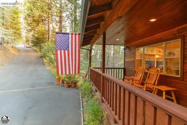 a view of a porch with wooden floor and outdoor space