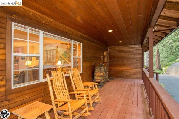 a view of a porch with wooden floor and fence