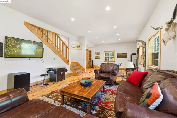 a room with pool table and windows