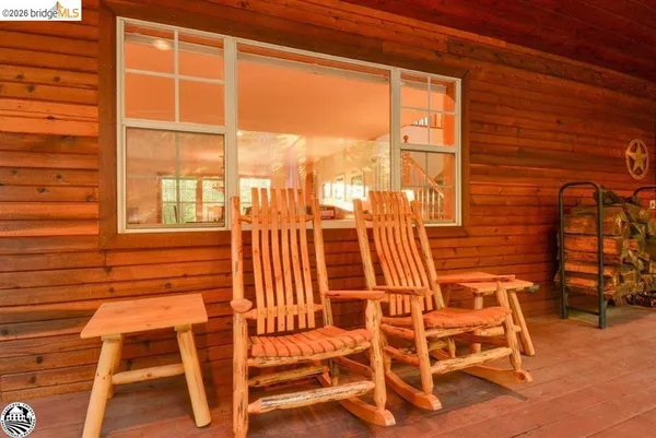 a view of a balcony with a large window and wooden floor