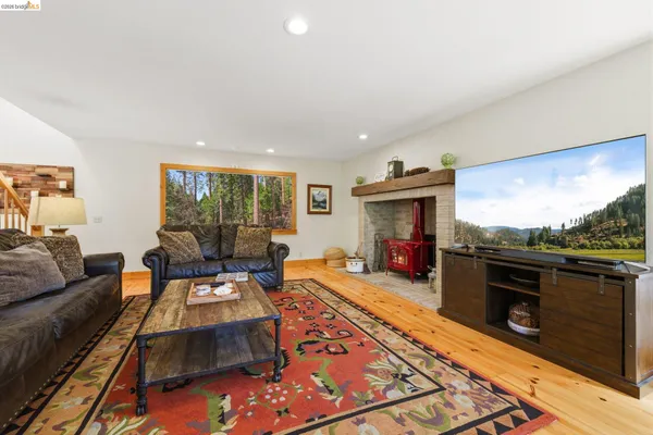 a living room with furniture flat screen tv and a fireplace