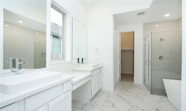 a bathroom with a granite countertop sink mirror and shower