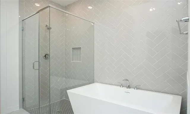 a bathroom with a bathtub and a shower
