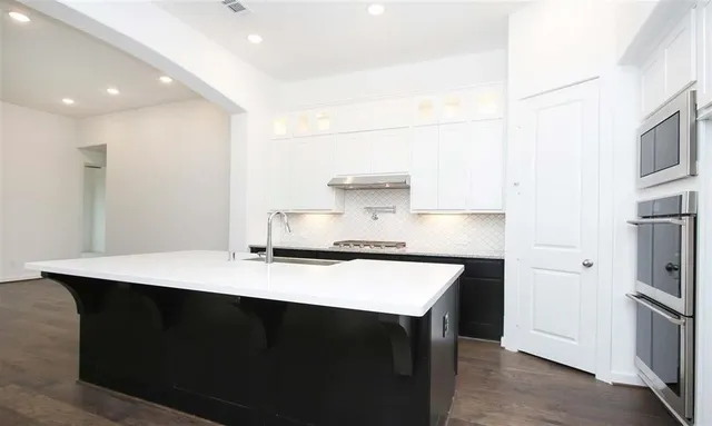 a kitchen with a sink a stove and refrigerator