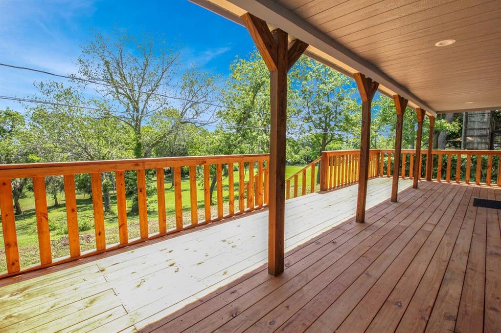 a view of wooden deck with a yard