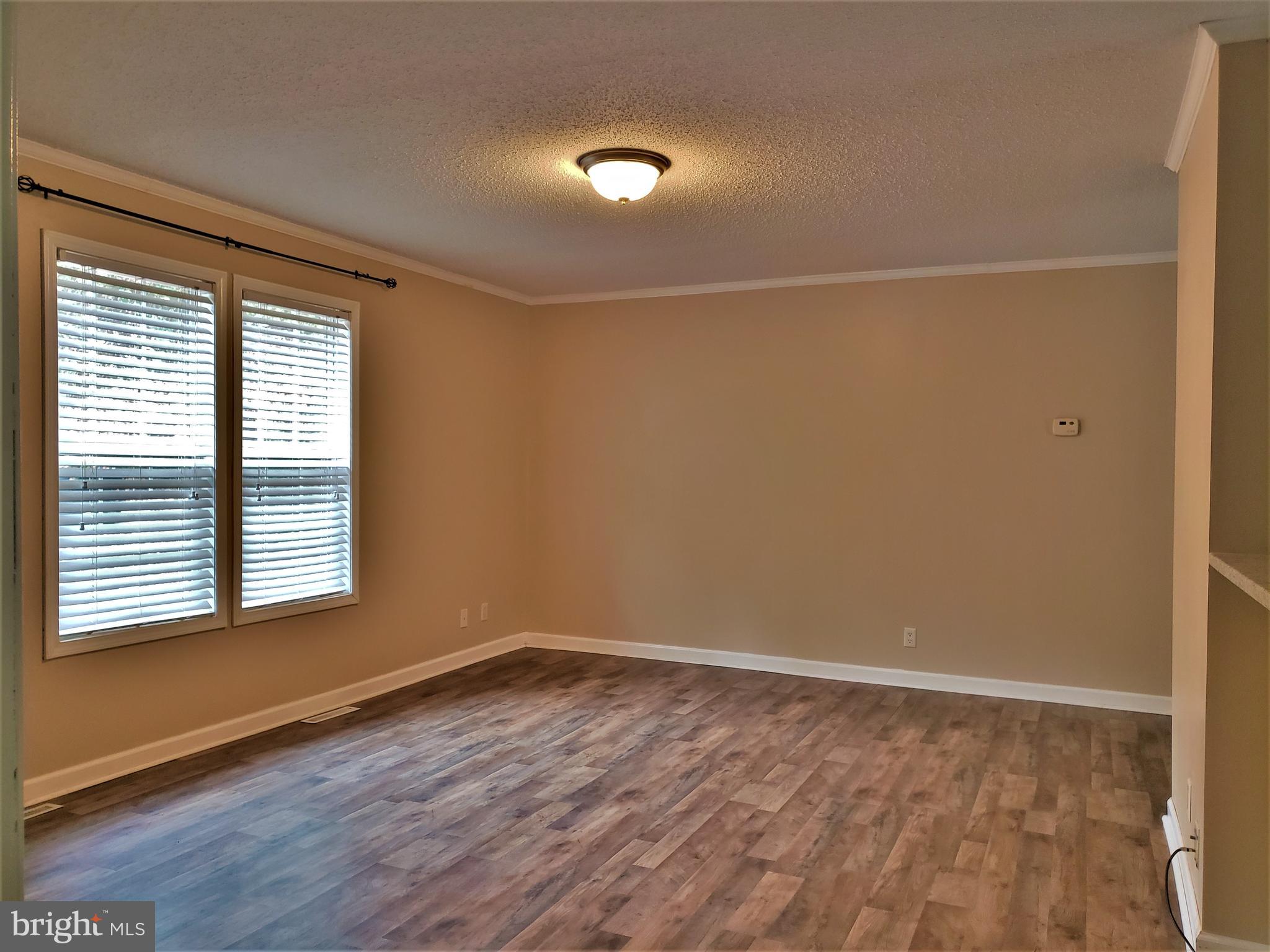 7515 Tate Road Ruther Glen, VA 22546 - Photo 8 of 28 Beautiful laminate plank flooring grace the home