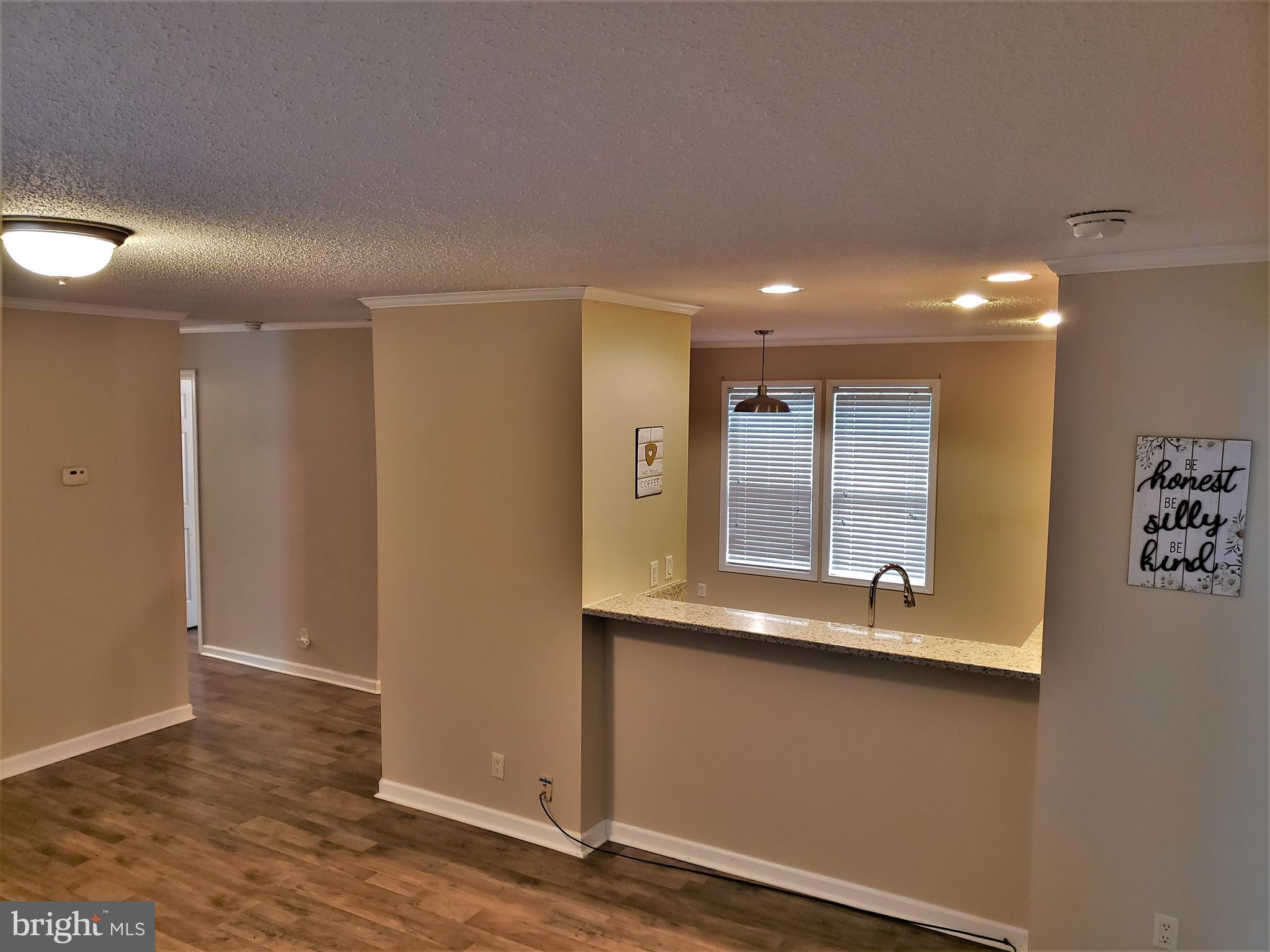 7515 Tate Road Ruther Glen, VA 22546 - Photo 10 of 28 Opens to kitchen and seating at countertop bar...