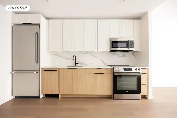 a view of a kitchen with electric appliances