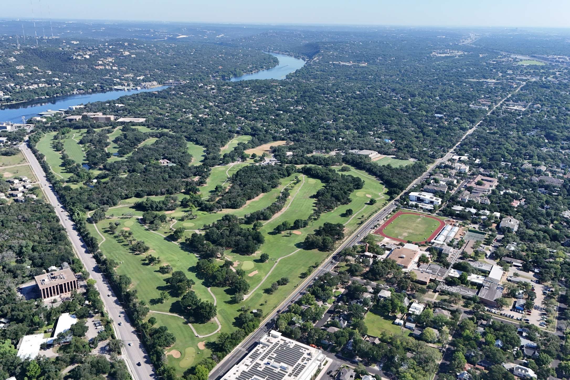 2208 Enfield Road, Unit 10500 Austin, TX 78703 - Photo 33 of 34 Aerial perspective showcasing a sprawling golf course with mature trees, surrounded by extensive green spaces