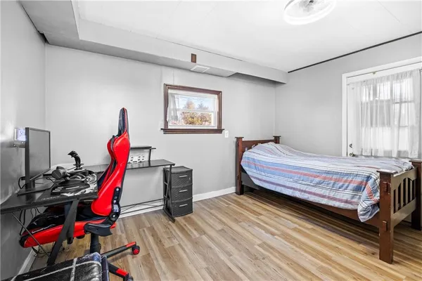 a bedroom with bed and a chandelier