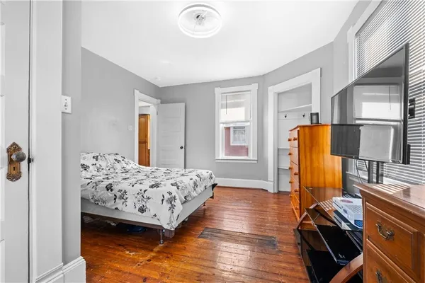 a bedroom with bed and window