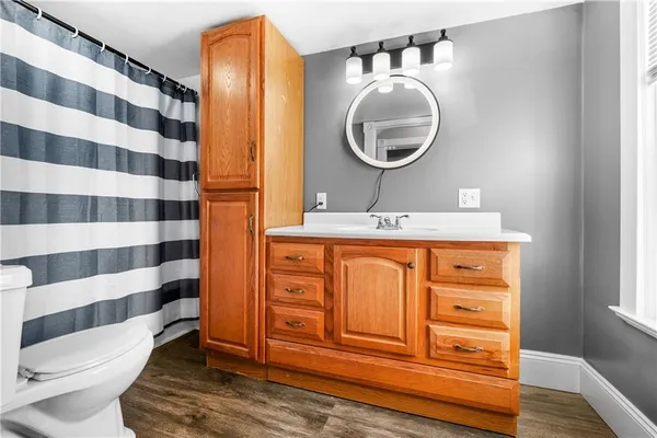 a bathroom with a sink a toilet and a mirror