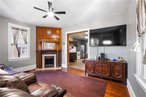 a living room with furniture a flat screen tv and a fireplace