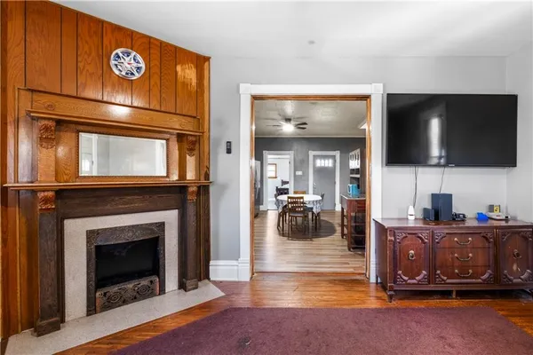 a living room with furniture a flat screen tv and a fireplace