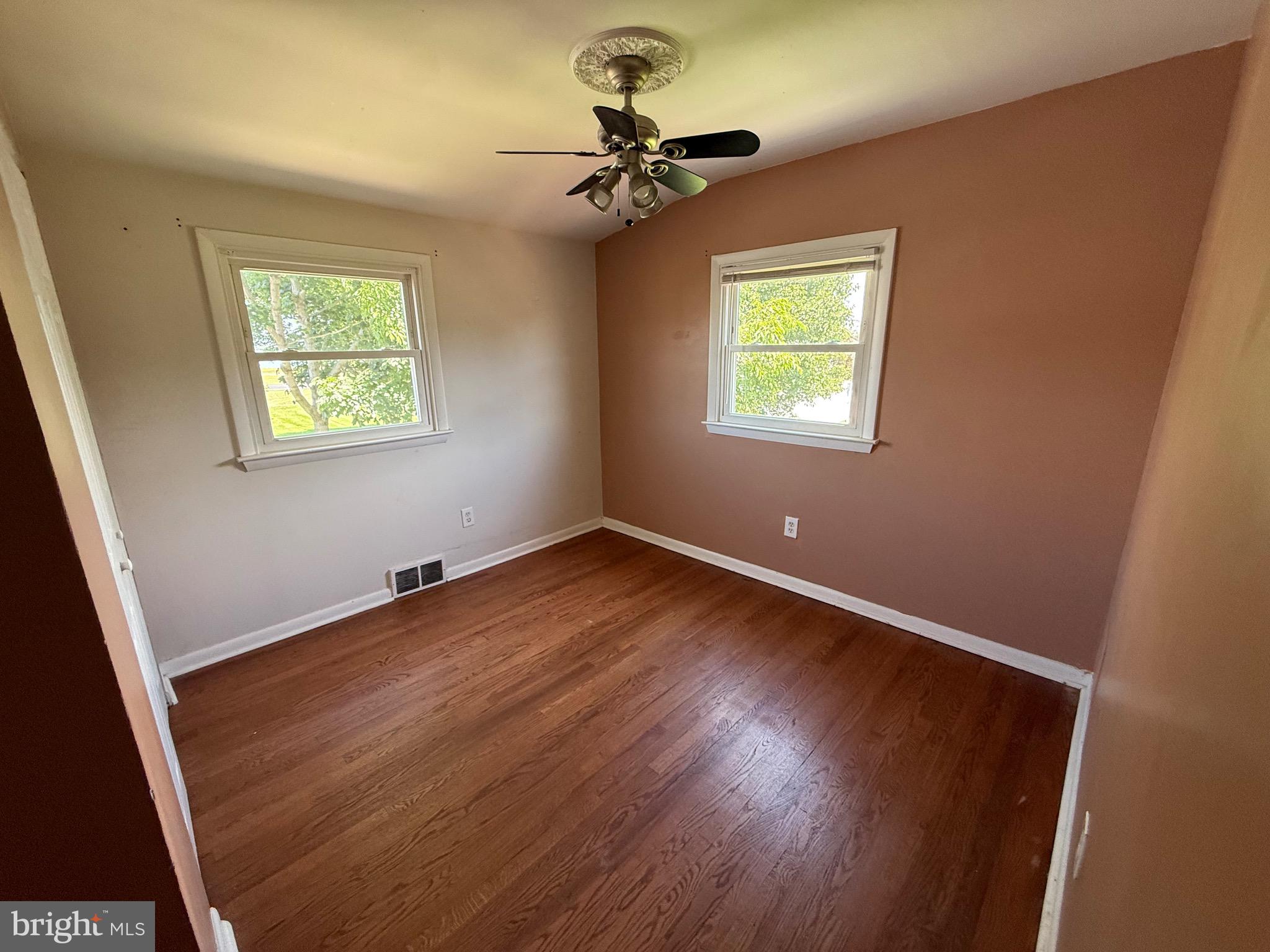 174 Kansas Road Pennsville, NJ 08070 - Photo 20 of 22 wooden floor in an empty room with a window