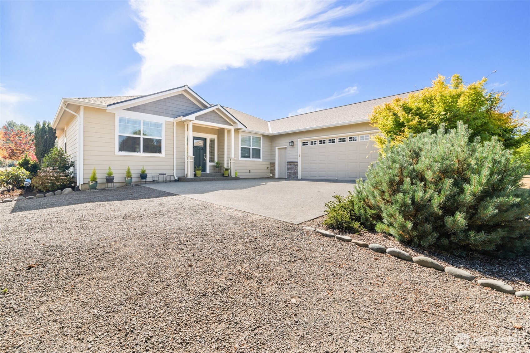 a front view of a house with a yard and a garage
