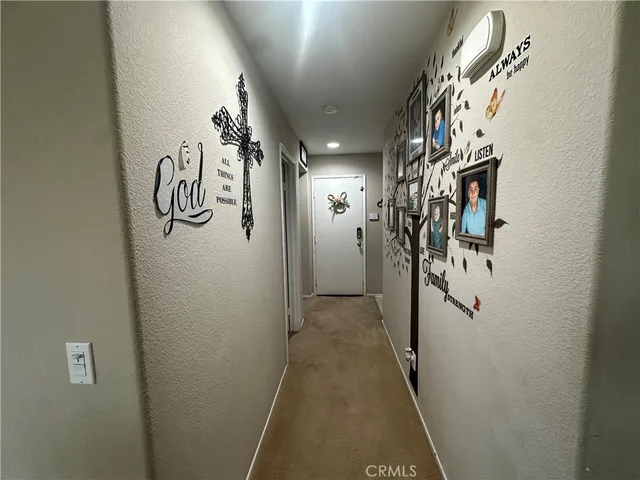 a spacious bedroom with a bed and a chandelier