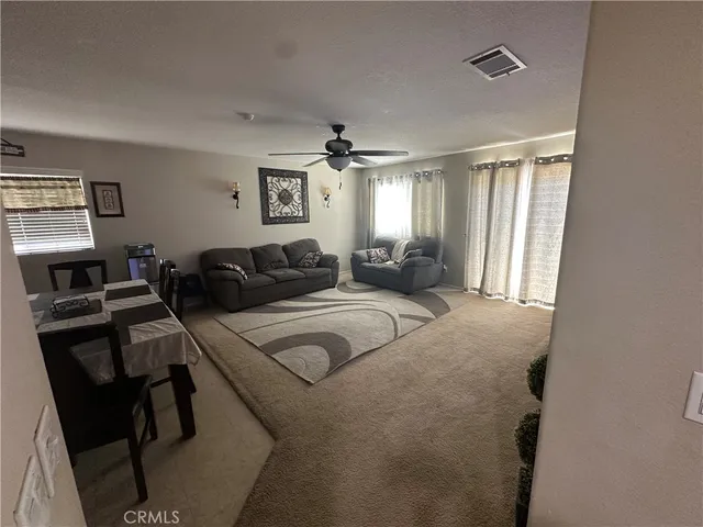 a large bedroom with a bed and large windows