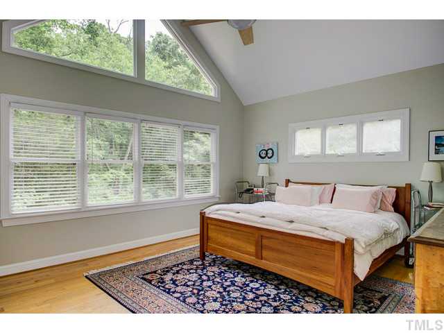 239 Stable Road Carrboro, NC 27510 - Photo 9 of 25 The 14' x 16' MASTER BEDROOM features plenty of windows (overlooking HOA owned woodlands) and hardwood floors.