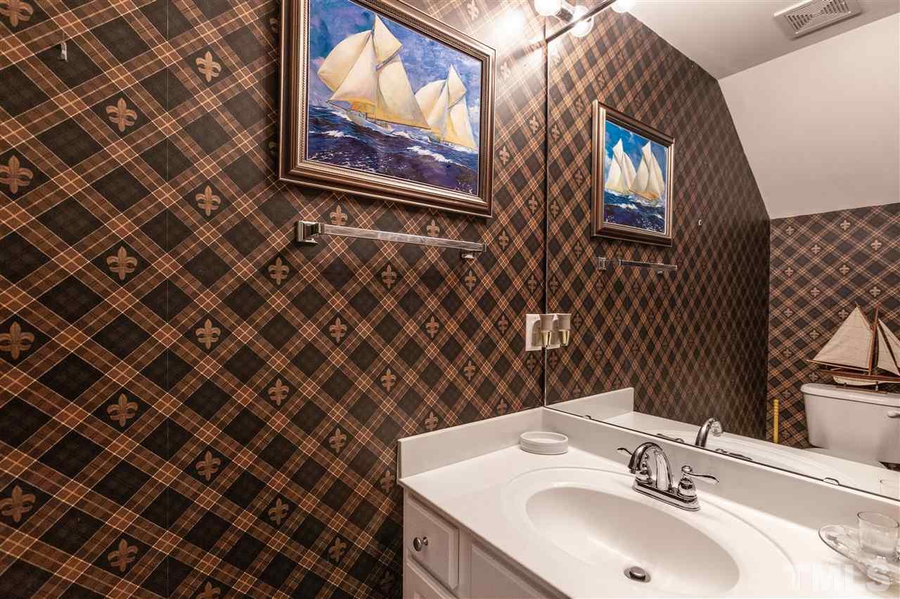 5503 Red Robin Road Raleigh, NC 27613 - Photo 22 of 25 a bathroom with a sink and a mirror