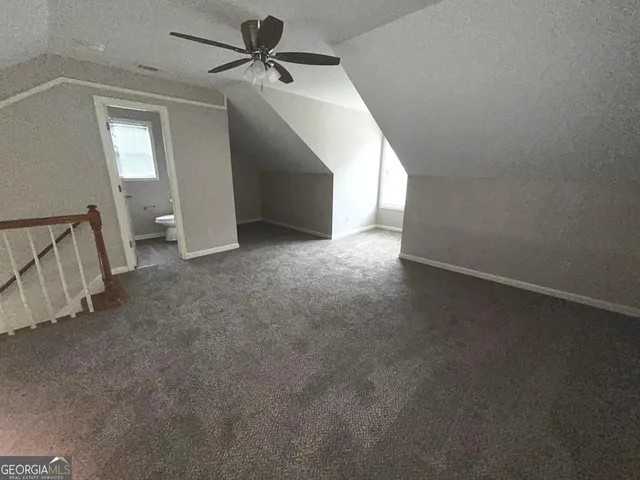 a view of a big room with closet and windows