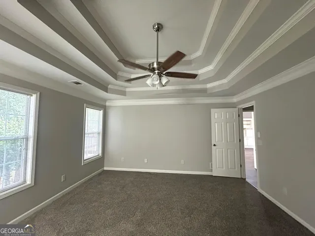 a view of a livingroom with a ceiling fan and window