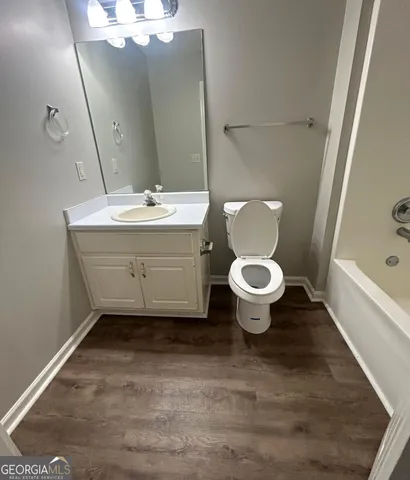 a bathroom with a sink toilet and a mirror