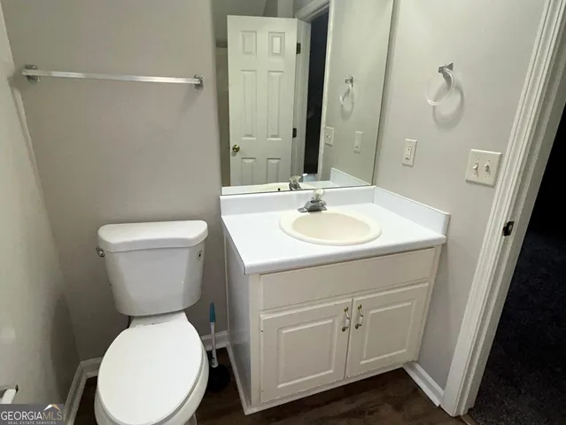 a bathroom with a toilet sink and mirror