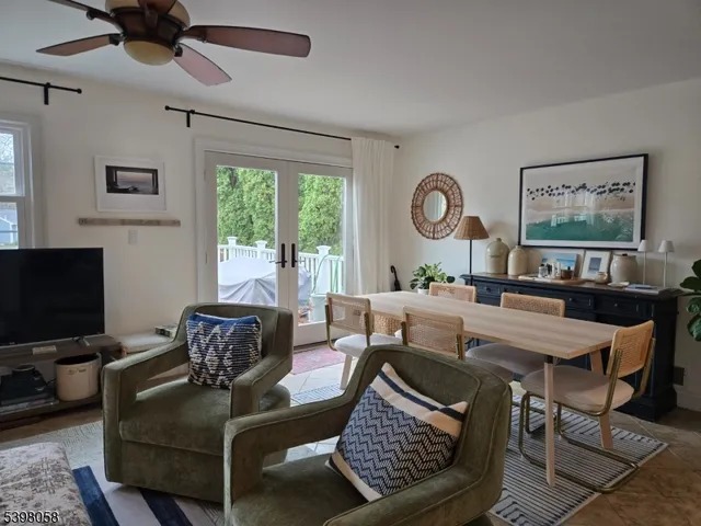 a living room with furniture a large window and a flat screen tv