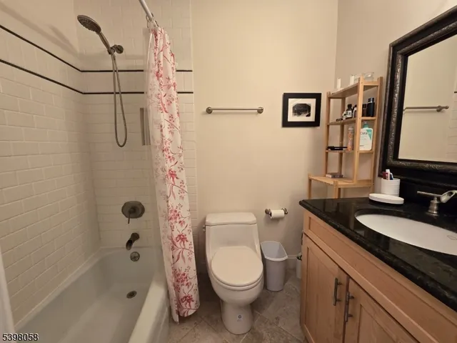 a bathroom with a granite countertop toilet sink and shower
