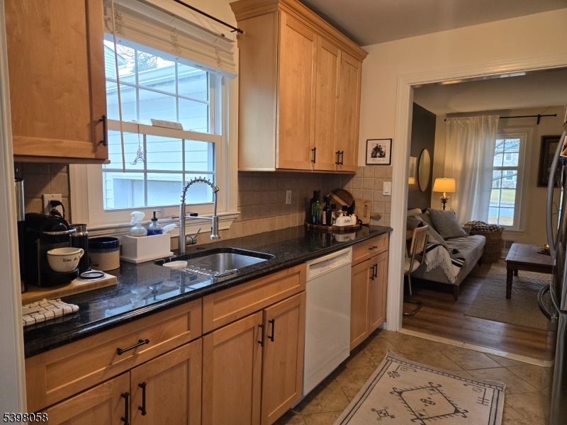 87 East Main Street, Unit 87B Mendham, NJ 07945 - Photo 7 of 27 a kitchen with sink cabinets and outdoor view