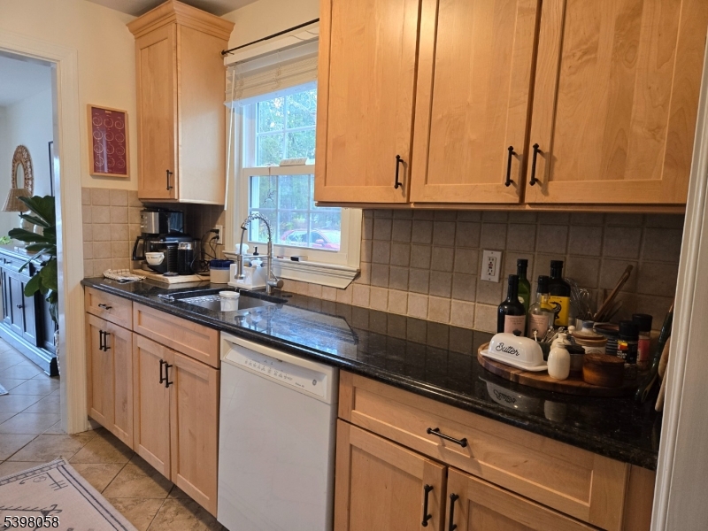 87 East Main Street, Unit 87B Mendham, NJ 07945 - Photo 8 of 27 a kitchen with stainless steel appliances granite countertop white cabinets and a sink