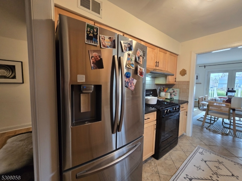 87 East Main Street, Unit 87B Mendham, NJ 07945 - Photo 9 of 27 a kitchen with stainless steel appliances granite countertop a refrigerator and a stove