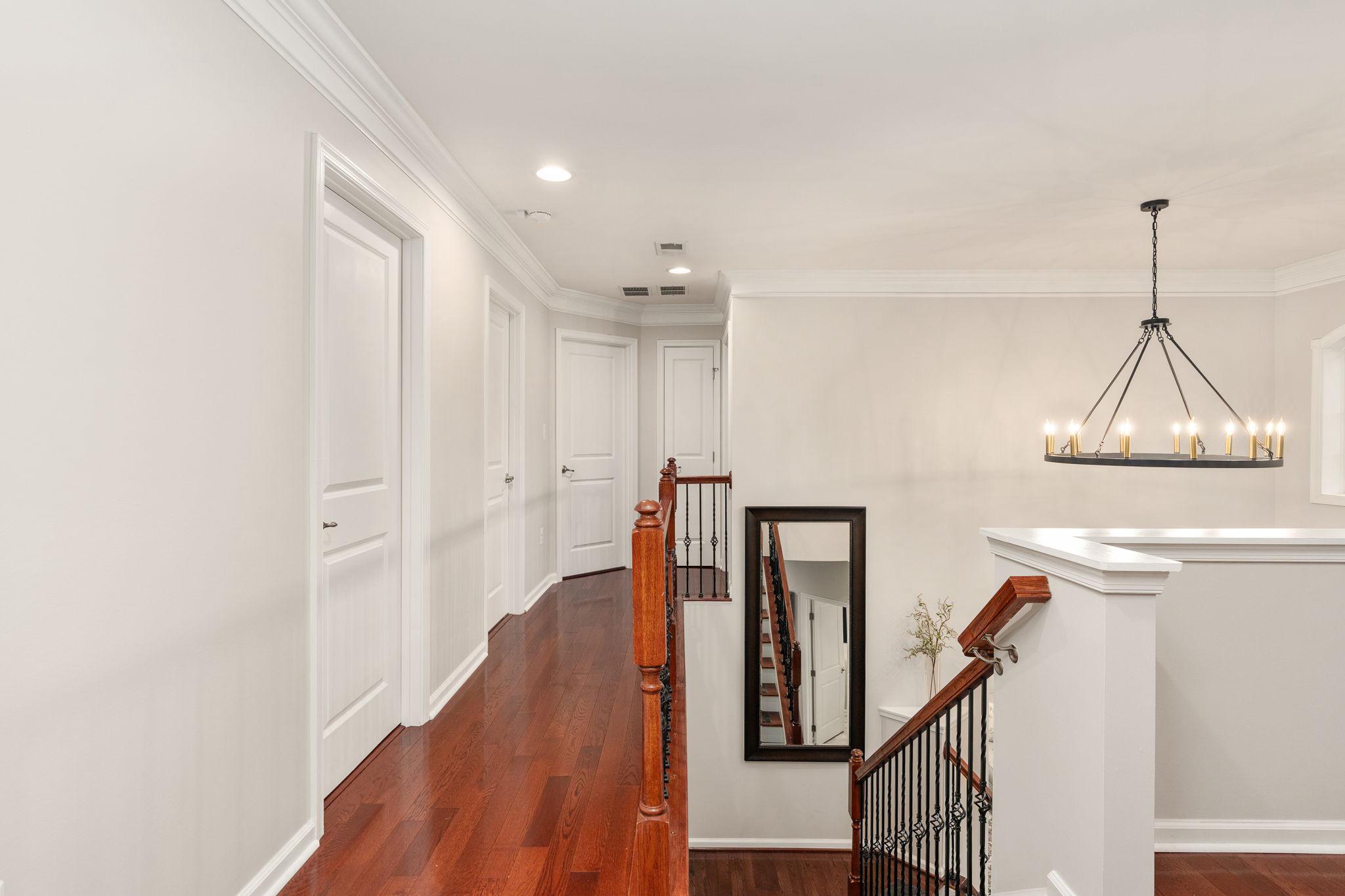 9417 Reservoir Road Fredericksburg, VA 22407 - Photo 47 of 76 a view of a hallway with wooden floor and staircase
