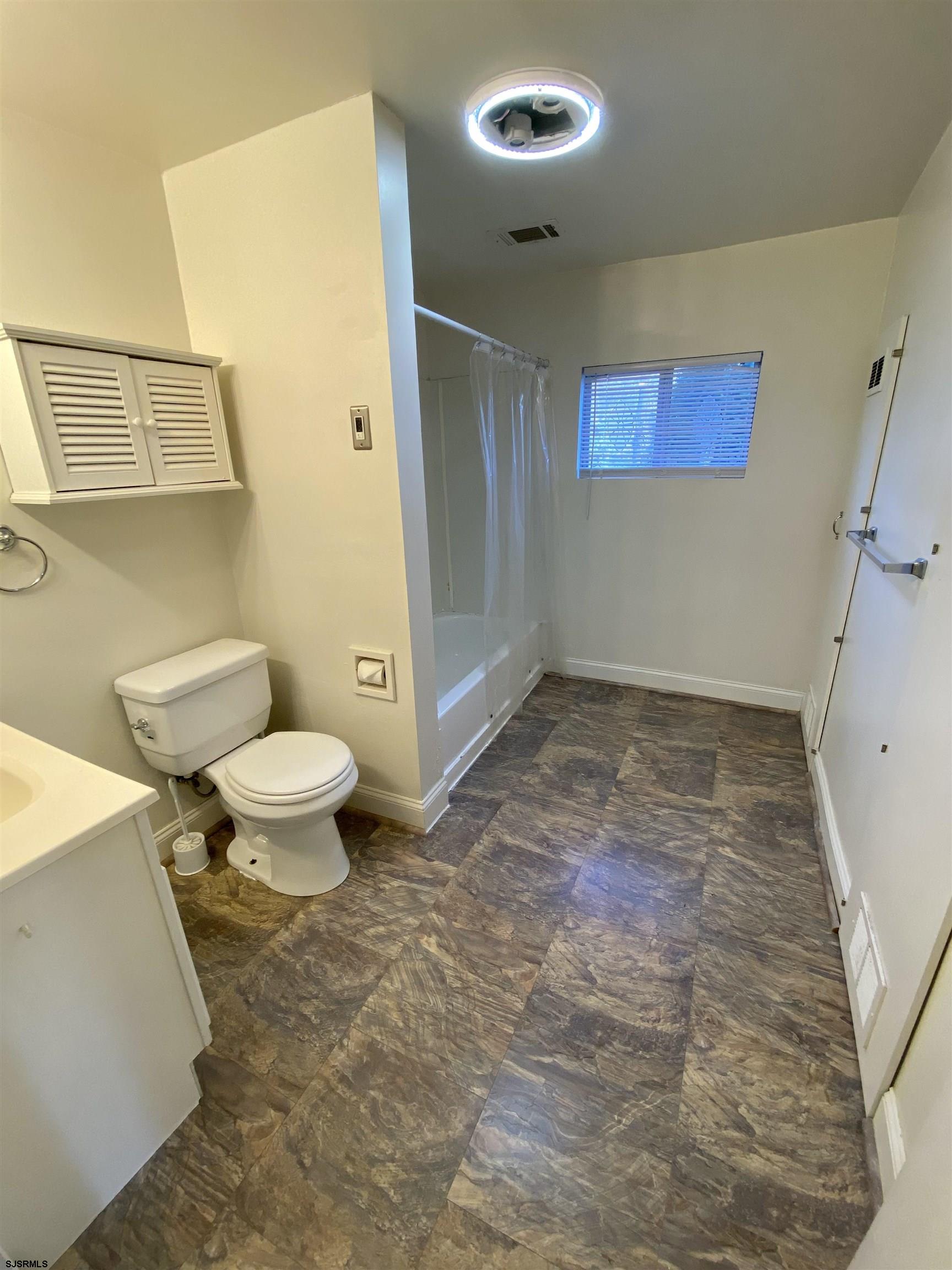 201 Broad Street Milmay, NJ 08340 - Photo 11 of 23 a bathroom with a toilet a sink and a mirror