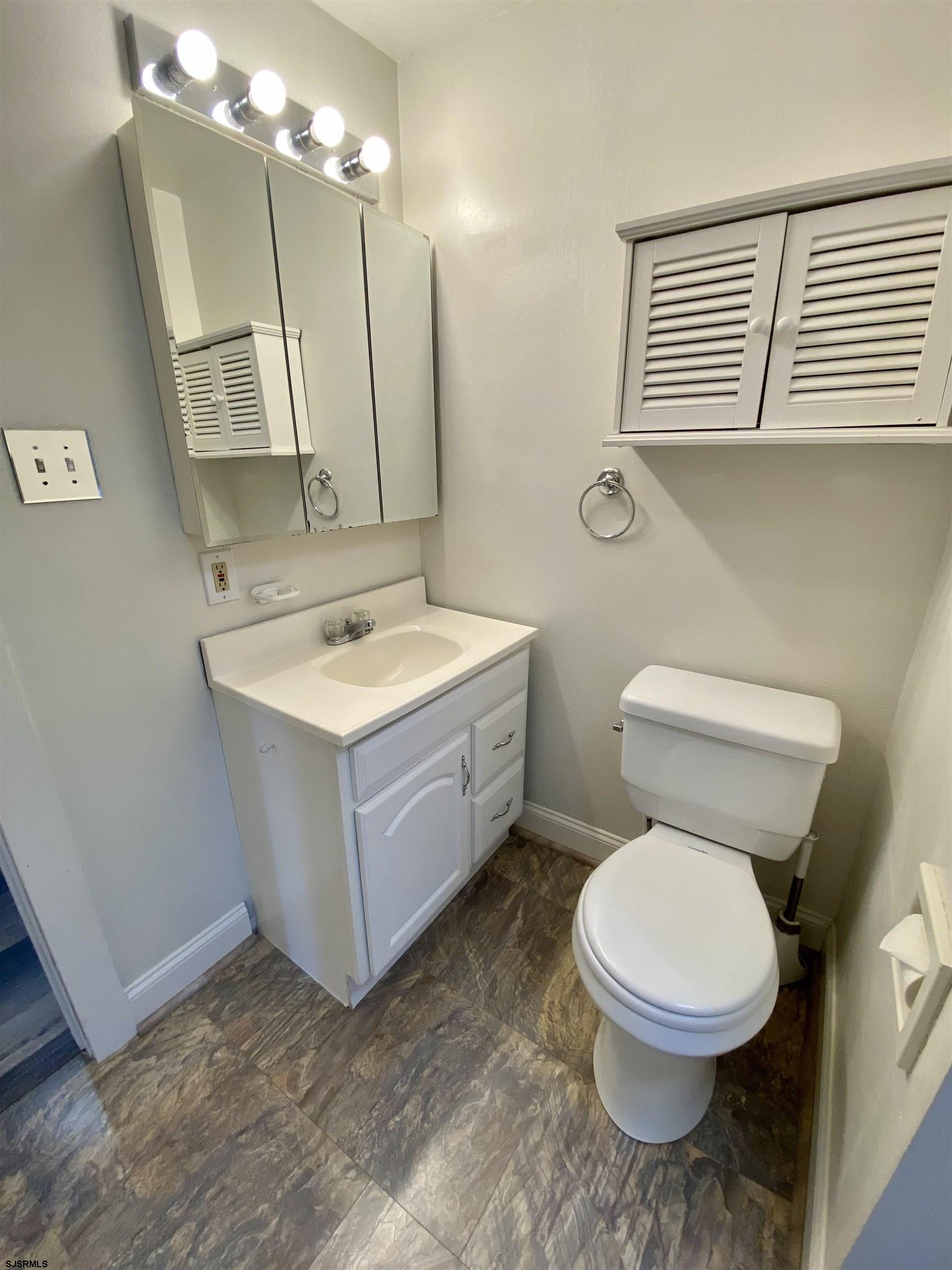 201 Broad Street Milmay, NJ 08340 - Photo 12 of 23 a bathroom with a toilet sink and mirror