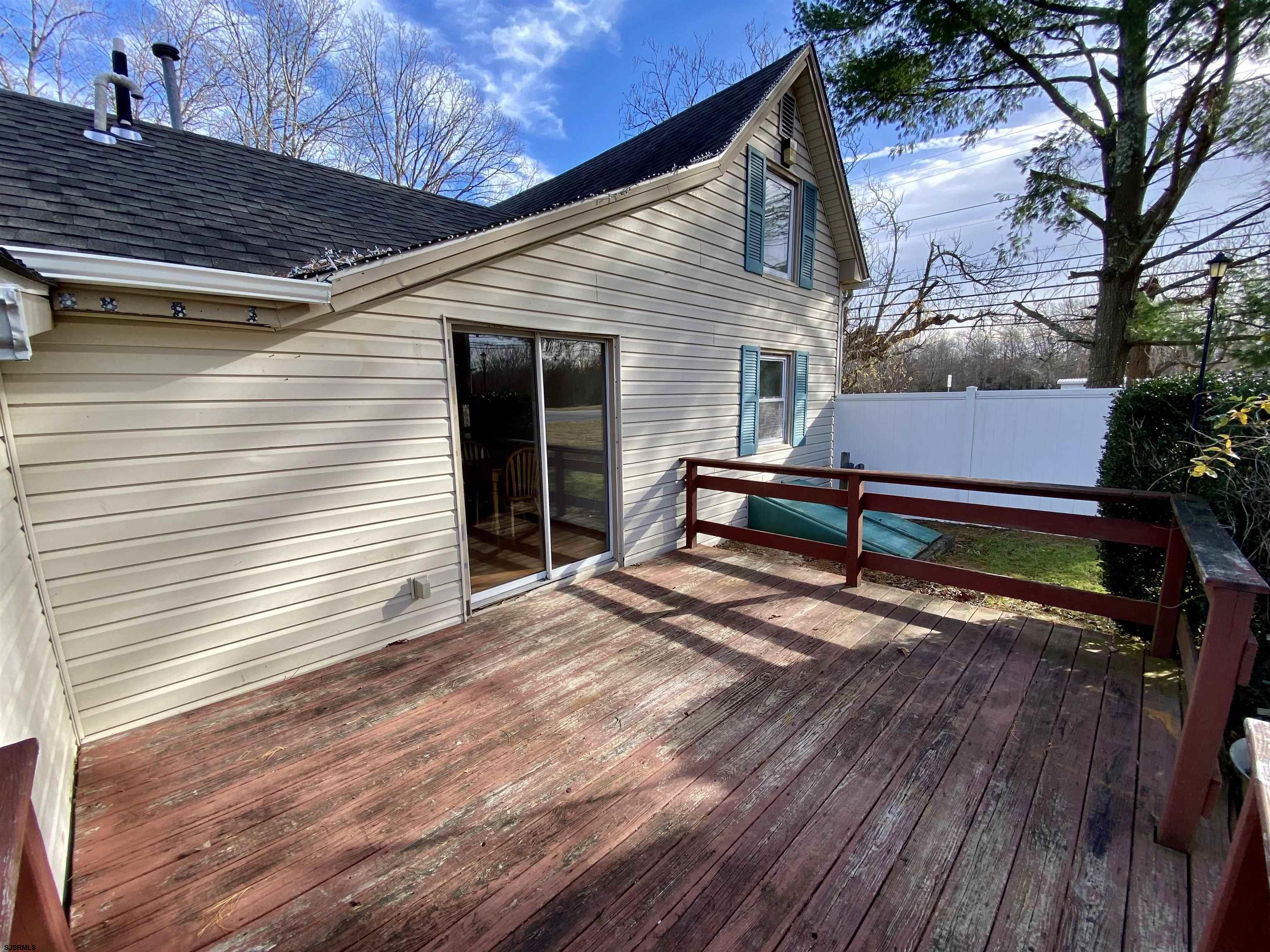201 Broad Street Milmay, NJ 08340 - Photo 17 of 23 a view of a backyard with a wooden fence