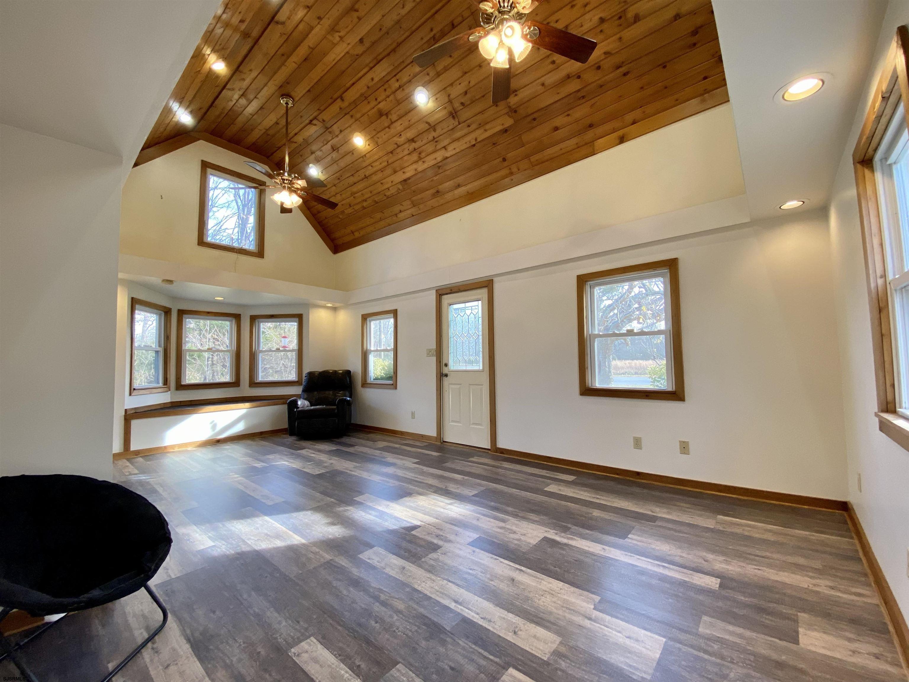 201 Broad Street Milmay, NJ 08340 - Photo 3 of 23 a view of a livingroom with wooden floor and a large window