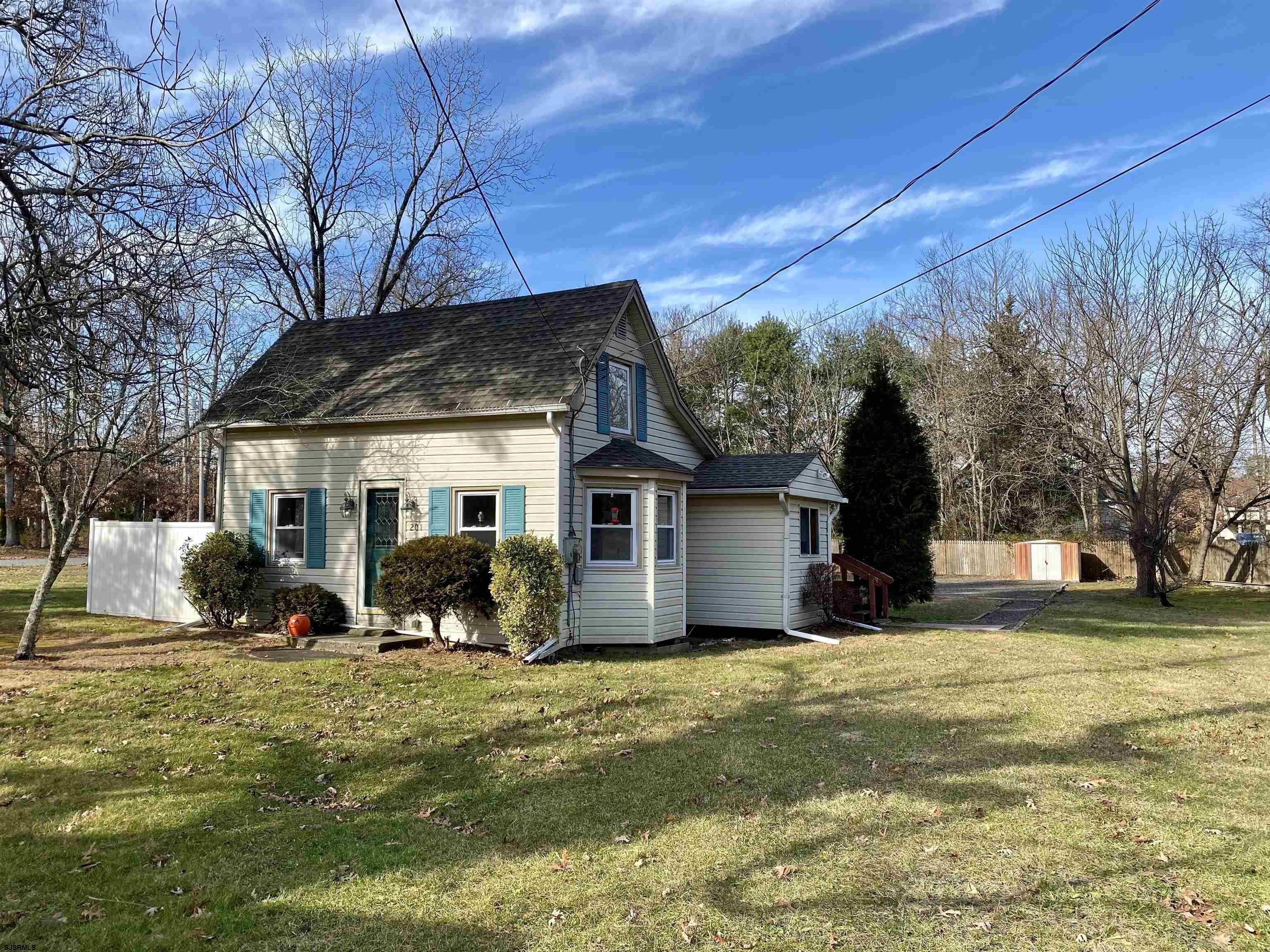 201 Broad Street Milmay, NJ 08340 - Photo 23 of 23 a front view of house with yard and trees around