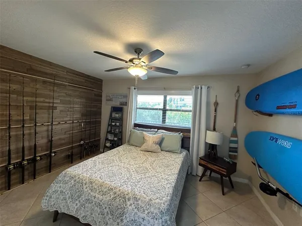 a bedroom with a bed a chandelier and dresser