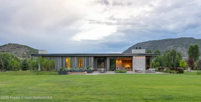 a view of a house with a yard and sitting area