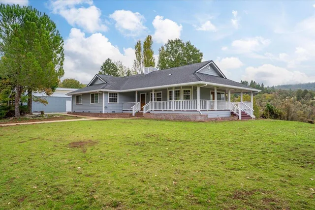 a view of a house with a garden and lake view