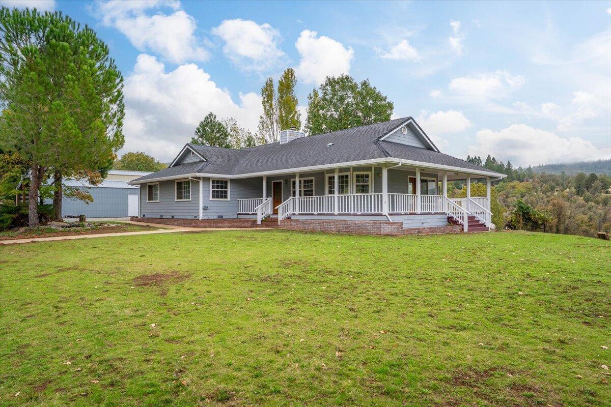 a view of a house with a garden and lake view