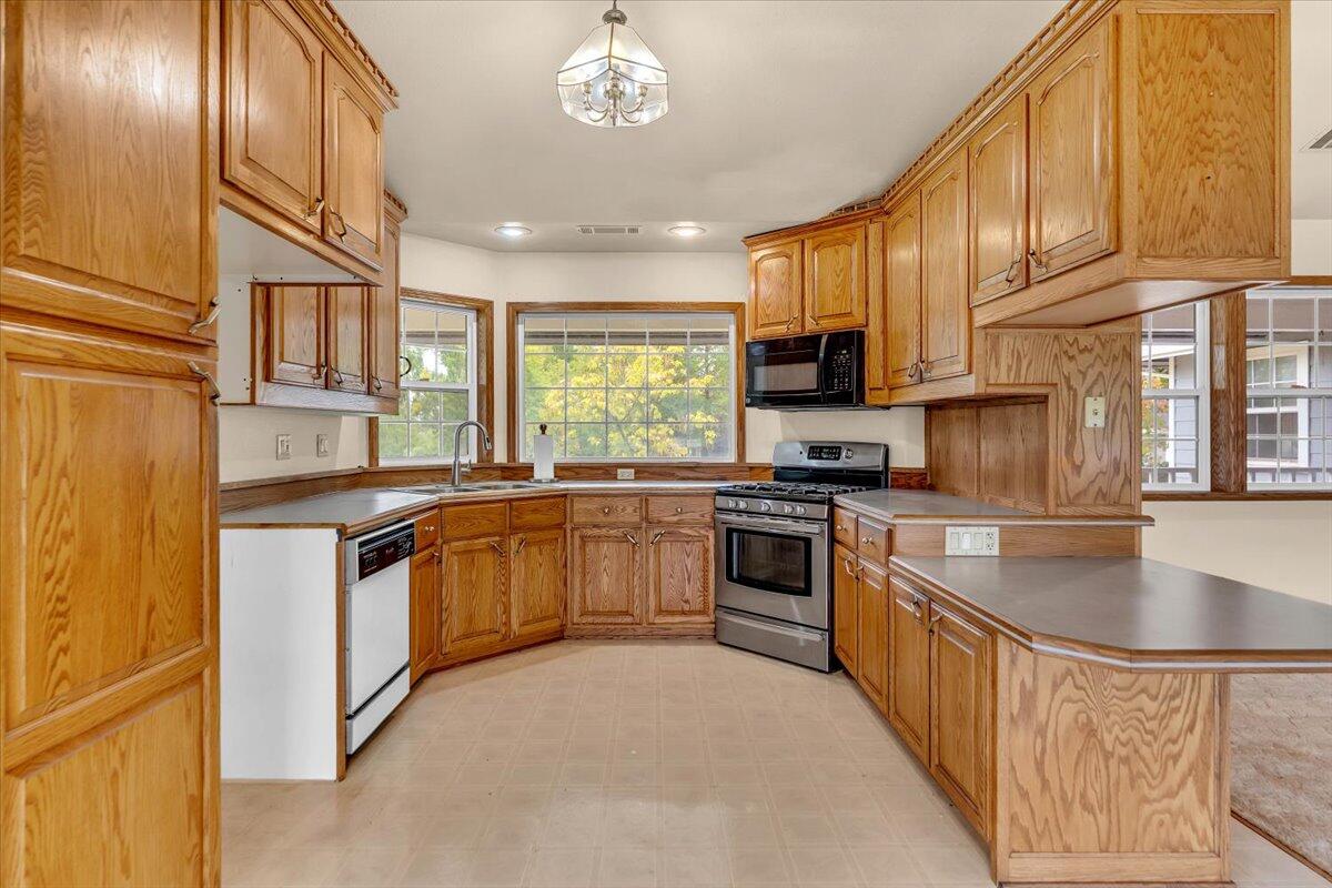 30153 Frisby Road Oak Run, CA 96069 - Photo 14 of 56 a kitchen with stainless steel appliances granite countertop a stove a sink and a microwave